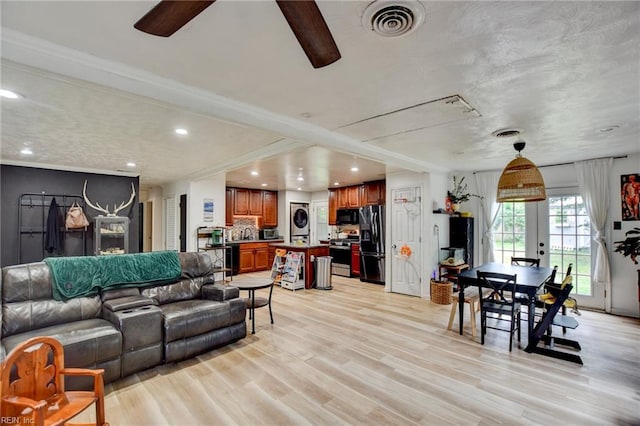 3521 Wayne St, Virginia Beach, VA 23452 - living room with stacked washer and clothes dryer, ceiling fan, ornamental molding, light wood-type flooring, and french doors