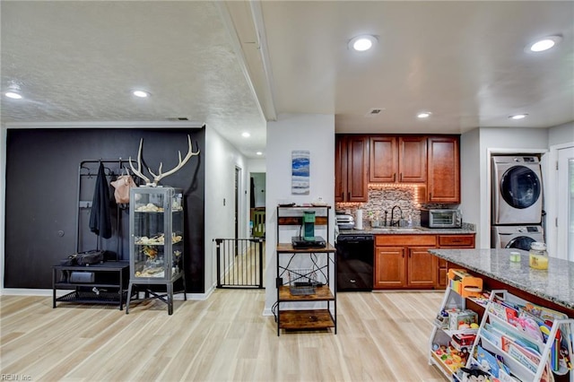 3521 Wayne St, Virginia Beach, VA 23452 - kitchen with estacked washer and dryer, dishwasher, a sink, light wood-style floors, and decorative backsplash