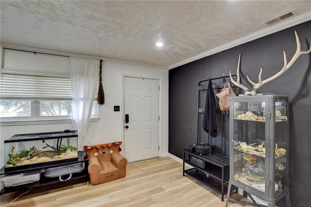 3521 Wayne St, Virginia Beach, VA 23452 - entryway with wood finished floors, a textured ceiling, and crown molding