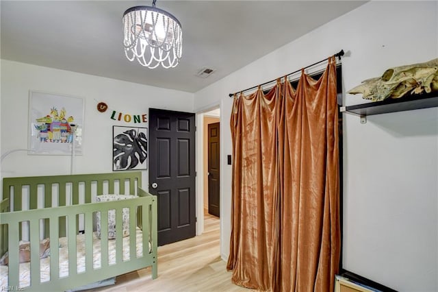 3521 Wayne St, Virginia Beach, VA 23452 - bedroom featuring light wood-style flooring and a chandelier
