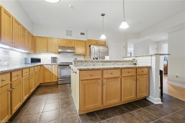 4250 Granby St Unit 109, Norfolk, VA 23504 - kitchen with stainless steel appliances, under cabinet range hood, decorative backsplash, and dark tile patterned floors