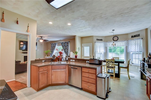 1757 Brigands Way, Virginia Beach, VA 23453 - kitchen with stainless steel dishwasher, a sink, decorative light fixtures, brown cabinets, and baseboards