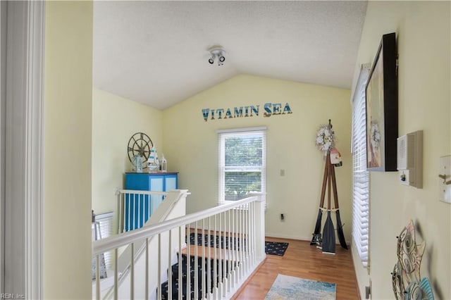 1026 High Dunes Quay Quay Unit 201, Hampton, VA 23664 - hallway featuring vaulted ceiling, wood finished floors, an upstairs landing, and baseboards