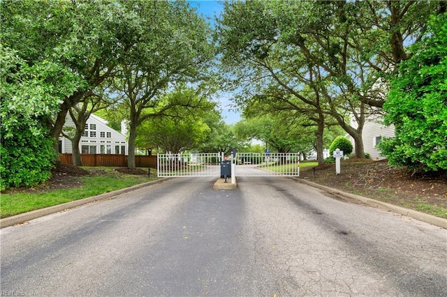 1026 High Dunes Quay Quay Unit 201, Hampton, VA 23664 - view of asphalt road featuring curbs, a gate, and a gated entry