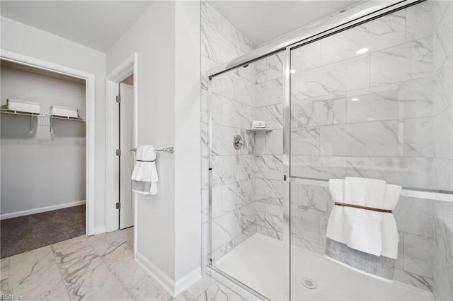 3031 Dalton Cir, Suffolk, VA 23435 - bathroom featuring marble look tile flooring, baseboards, a spacious closet, and a marble finish shower