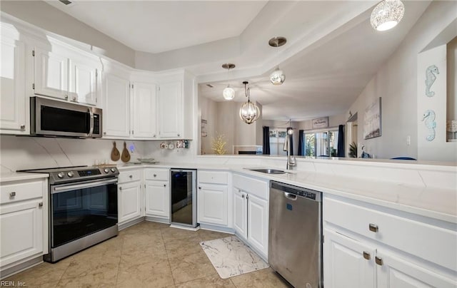 1031 High Dunes Quay Quay Unit 103, Hampton, VA 23664 - kitchen featuring appliances with stainless steel finishes, a sink, wine cooler, light countertops, and white cabinetry
