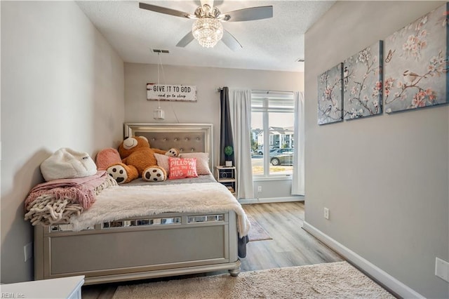 1031 High Dunes Quay Quay Unit 103, Hampton, VA 23664 - bedroom with light wood finished floors, a textured ceiling, baseboards, and a ceiling fan