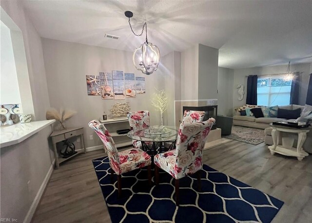 1031 High Dunes Quay Quay Unit 103, Hampton, VA 23664 - dining room with wood finished floors, a chandelier, and baseboards