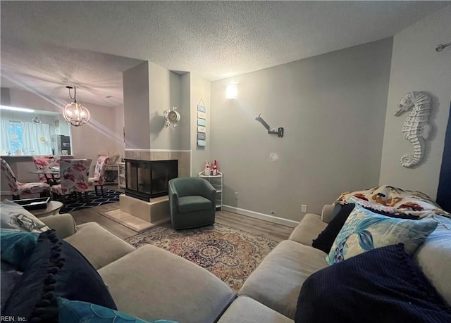 1031 High Dunes Quay Quay Unit 103, Hampton, VA 23664 - living room with wood finished floors, a textured ceiling, a chandelier, and baseboards