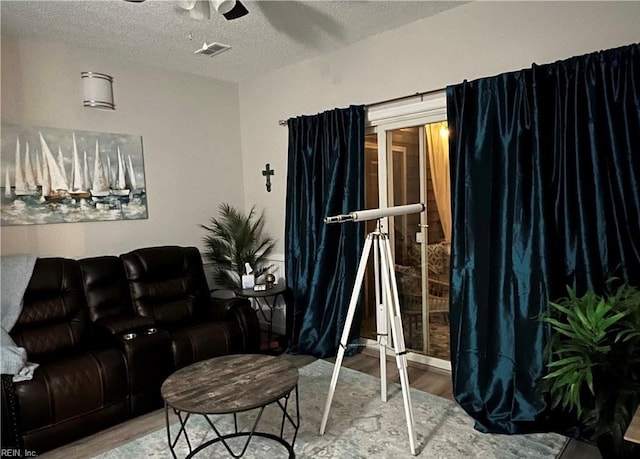 1031 High Dunes Quay Quay Unit 103, Hampton, VA 23664 - living area with wood finished floors, ceiling fan, and a textured ceiling
