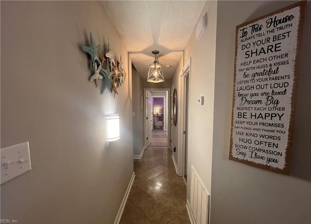 1031 High Dunes Quay Quay Unit 103, Hampton, VA 23664 - hall featuring a textured ceiling, dark tile patterned floors, and baseboards