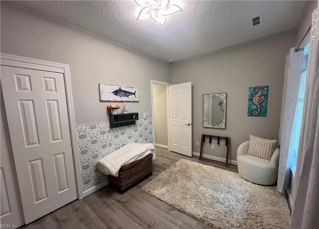 1031 High Dunes Quay Quay Unit 103, Hampton, VA 23664 - sitting room featuring wood finished floors, baseboards, and a textured ceiling