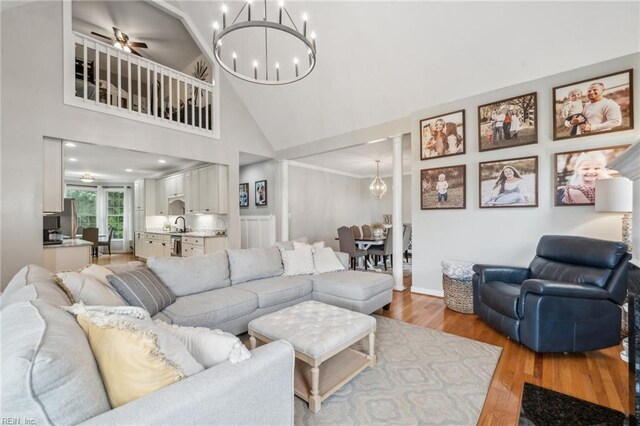 183 Belle Aire Dr, Hardyville, VA 23070 - living area featuring a chandelier, high vaulted ceiling, light wood-style flooring, decorative columns, and ceiling fan