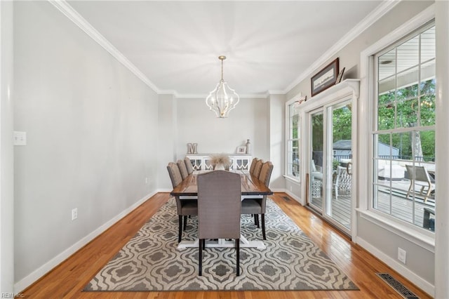183 Belle Aire Dr, Hardyville, VA 23070 - dining room featuring a chandelier, light wood-type flooring, crown molding, and baseboards