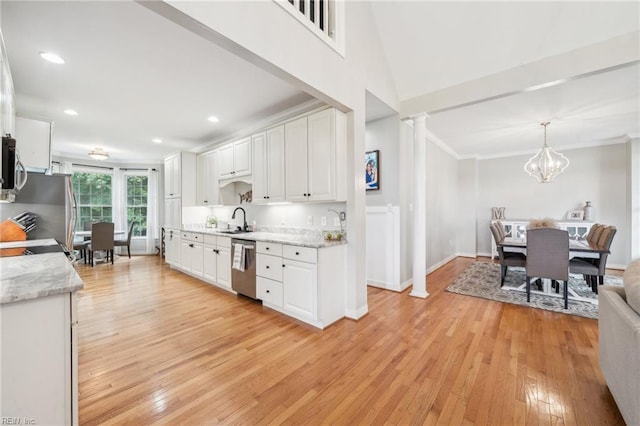 183 Belle Aire Dr, Hardyville, VA 23070 - kitchen featuring appliances with stainless steel finishes, white cabinets, light wood-style floors, ornamental molding, and a sink