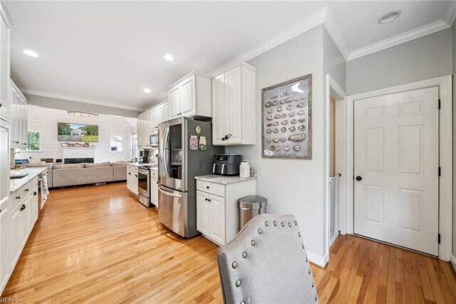 183 Belle Aire Dr, Hardyville, VA 23070 - kitchen featuring appliances with stainless steel finishes, crown molding, white cabinetry, light wood finished floors, and recessed lighting