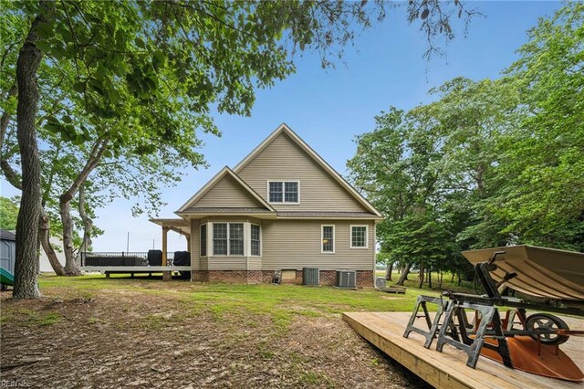 183 Belle Aire Dr, Hardyville, VA 23070 - back of property with a deck, central air condition unit, and a lawn
