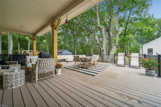183 Belle Aire Dr, Hardyville, VA 23070 - deck featuring an outdoor living space, outdoor dining space, view of scattered trees, and grilling area