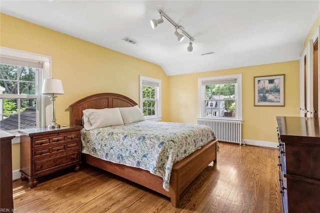 28 Shirley Rd, Newport News, VA 23601 - bedroom featuring radiator heating unit, wood finished floors, lofted ceiling, rail lighting, and baseboards