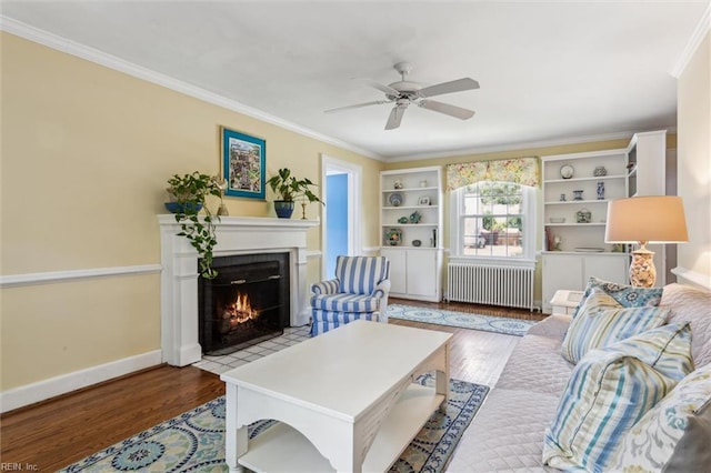 28 Shirley Rd, Newport News, VA 23601 - living room with radiator, a fireplace with flush hearth, wood finished floors, a ceiling fan, and ornamental molding