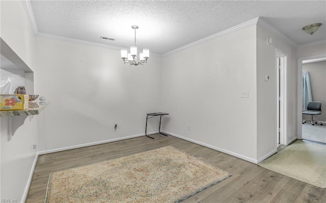 403 Joel Ct, Newport News, VA 23608 - unfurnished dining area with a chandelier, wood finished floors, ornamental molding, a textured ceiling, and baseboards