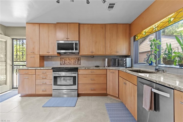 224 Iroquois Rd, Virginia Beach, VA 23462 - kitchen featuring appliances with stainless steel finishes, a sink, light stone countertops, and plenty of natural light