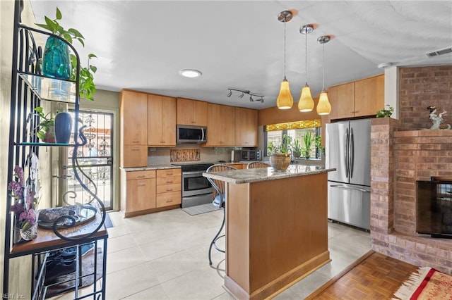 224 Iroquois Rd, Virginia Beach, VA 23462 - kitchen with stainless steel appliances, a center island, hanging light fixtures, a breakfast bar area, and light stone countertops
