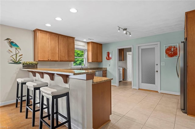 4680 Miles Standish Rd, Virginia Beach, VA 23455 - kitchen with appliances with stainless steel finishes, a peninsula, baseboards, a breakfast bar area, and recessed lighting
