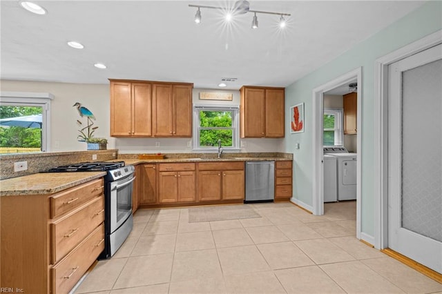 4680 Miles Standish Rd, Virginia Beach, VA 23455 - kitchen with appliances with stainless steel finishes, a sink, washing machine and dryer, plenty of natural light, and recessed lighting