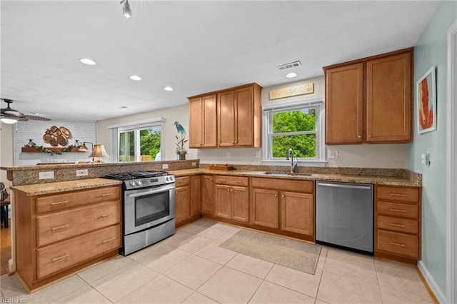 4680 Miles Standish Rd, Virginia Beach, VA 23455 - kitchen featuring stainless steel appliances, a sink, a peninsula, light stone countertops, and light tile patterned flooring
