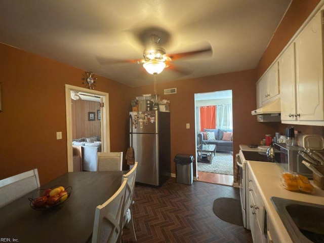 3904 Starboard Rd, Chesapeake, VA 23321 - kitchen with freestanding refrigerator, under cabinet range hood, white cabinetry, a ceiling fan, and range