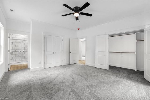1064 Tulls Creek Rd, Moyock, NC 27958 - unfurnished bedroom featuring ornamental molding, carpet floors, two closets, baseboards, and a ceiling fan