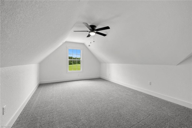 1064 Tulls Creek Rd, Moyock, NC 27958 - additional living space featuring baseboards, carpet floors, lofted ceiling, ceiling fan, and a textured ceiling