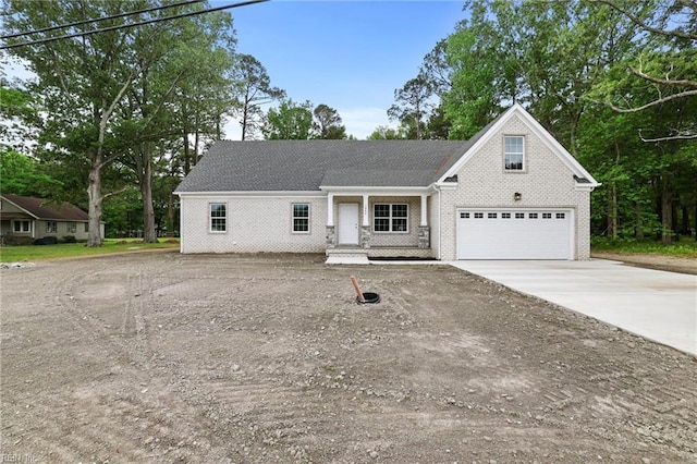 1064 Tulls Creek Rd, Moyock, NC 27958 - view of front of home with driveway, brick siding, and a garage
