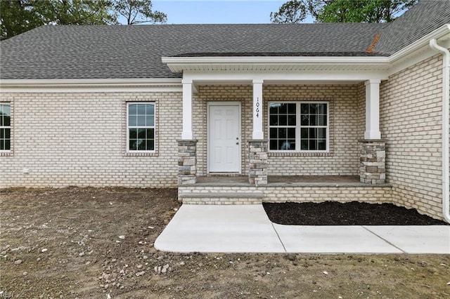 1064 Tulls Creek Rd, Moyock, NC 27958 - entrance to property featuring a porch, brick siding, and a shingled roof