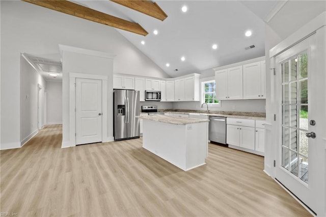 1064 Tulls Creek Rd, Moyock, NC 27958 - kitchen with appliances with stainless steel finishes, a center island, high vaulted ceiling, white cabinets, and recessed lighting