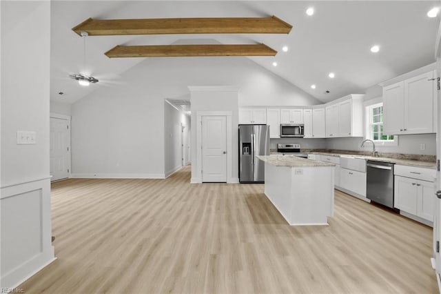1064 Tulls Creek Rd, Moyock, NC 27958 - kitchen with appliances with stainless steel finishes, a kitchen island, beamed ceiling, high vaulted ceiling, and white cabinets