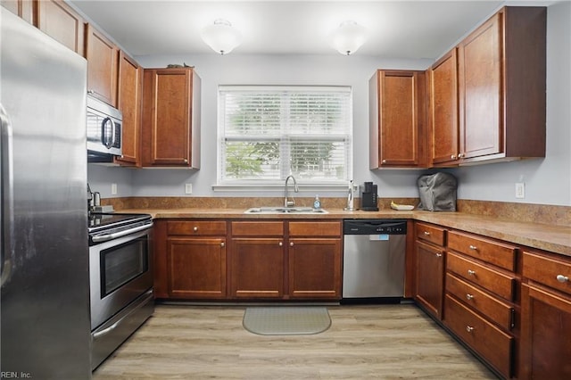 4316 Colindale Rd Unit 106, Chesapeake, VA 23321 - kitchen with appliances with stainless steel finishes, a sink, light wood-style floors, and brown cabinets