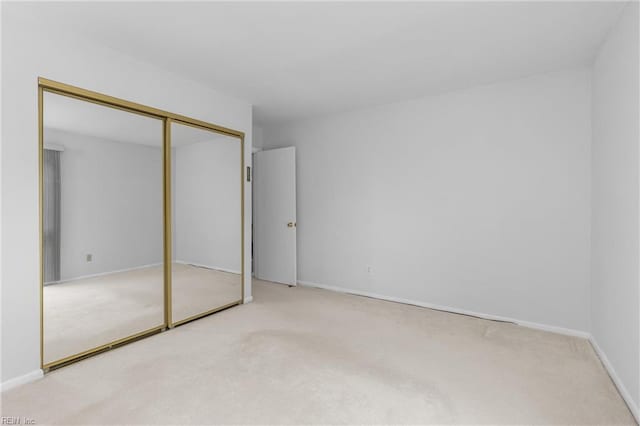 3934 Whispering Oaks Pl, Virginia Beach, VA 23455 - unfurnished bedroom featuring carpet flooring, a closet, and baseboards