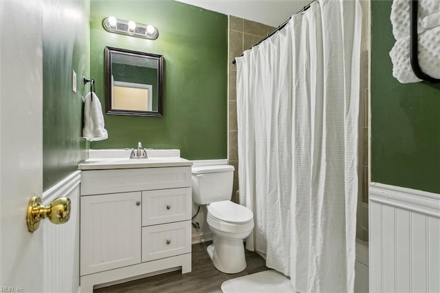118 Cove Rd, Newport News, VA 23608 - full bath featuring toilet, vanity, wainscoting, shower / bath combination with curtain, and wood finished floors