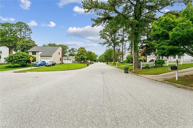 118 Cove Rd, Newport News, VA 23608 - view of asphalt street featuring a residential view, curbs, and traffic signs