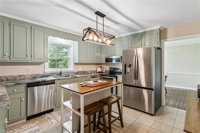 118 Cove Rd, Newport News, VA 23608 - kitchen featuring stainless steel appliances, green cabinets, light tile patterned flooring, a sink, and ornamental molding