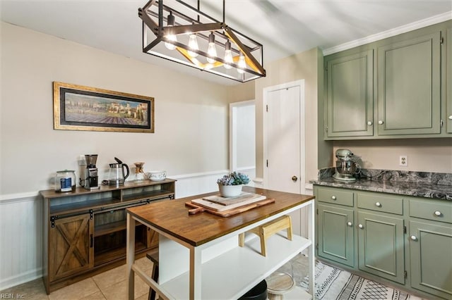 118 Cove Rd, Newport News, VA 23608 - kitchen featuring green cabinets, light tile patterned floors, a wainscoted wall, hanging light fixtures, and a chandelier