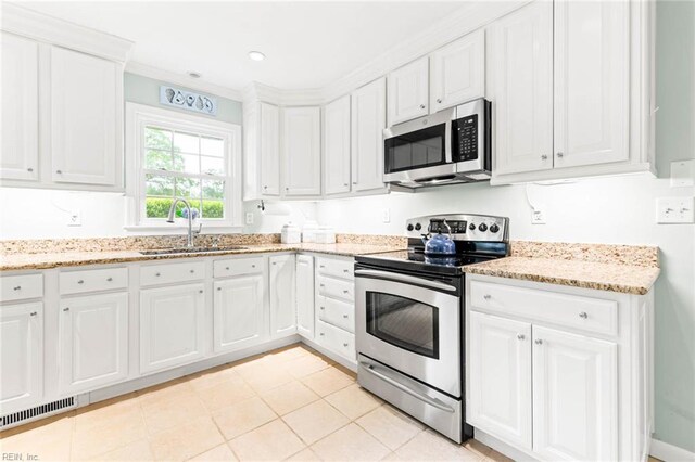 1808 Ashley Dr, Virginia Beach, VA 23454 - kitchen with appliances with stainless steel finishes, a sink, white cabinetry, light stone countertops, and crown molding