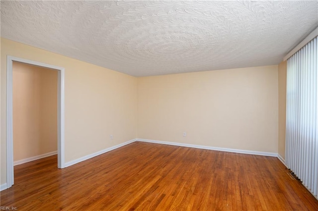 2304 Manning Rd, Suffolk, VA 23434 - unfurnished room with wood finished floors, a textured ceiling, and baseboards