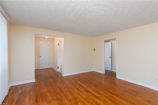 2304 Manning Rd, Suffolk, VA 23434 - unfurnished room with hardwood / wood-style flooring, baseboards, and a textured ceiling