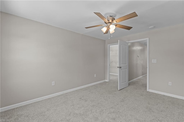 2905 Roanoke Ave, Newport News, VA 23607 - unfurnished bedroom featuring baseboards, light colored carpet, a ceiling fan, and a walk in closet