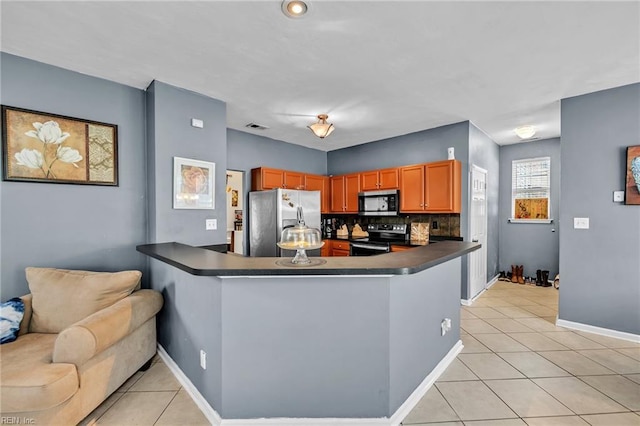 111 Windsor Ct, Suffolk, VA 23434 - kitchen with appliances with stainless steel finishes, dark countertops, light tile patterned floors, a peninsula, and baseboards