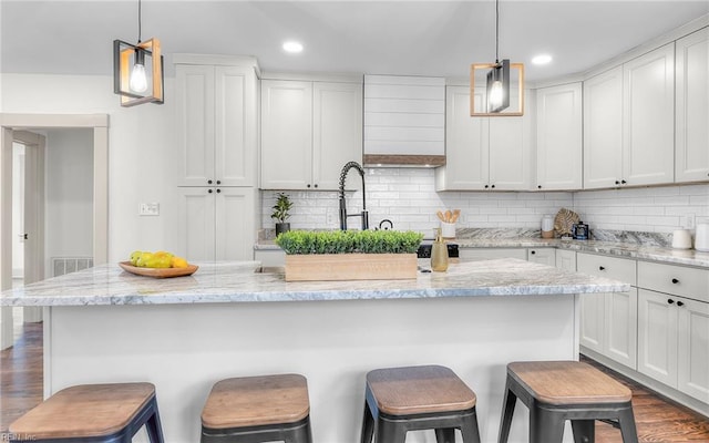 1006 Mayfield Ave, Chesapeake, VA 23324 - kitchen with white cabinetry, a kitchen breakfast bar, and recessed lighting