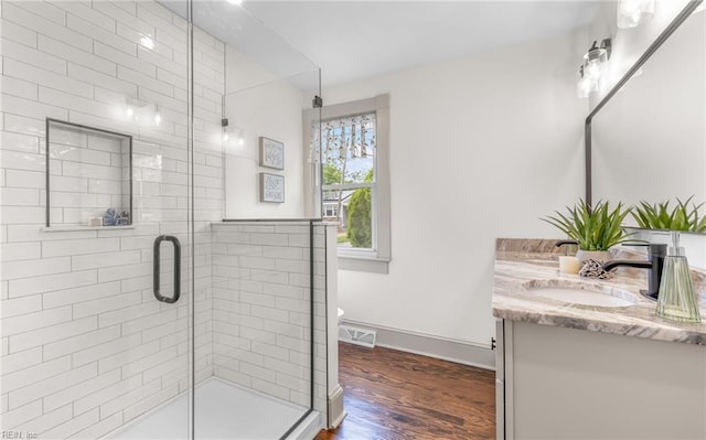1006 Mayfield Ave, Chesapeake, VA 23324 - full bathroom featuring vanity, a stall shower, wood finished floors, baseboards, and toilet